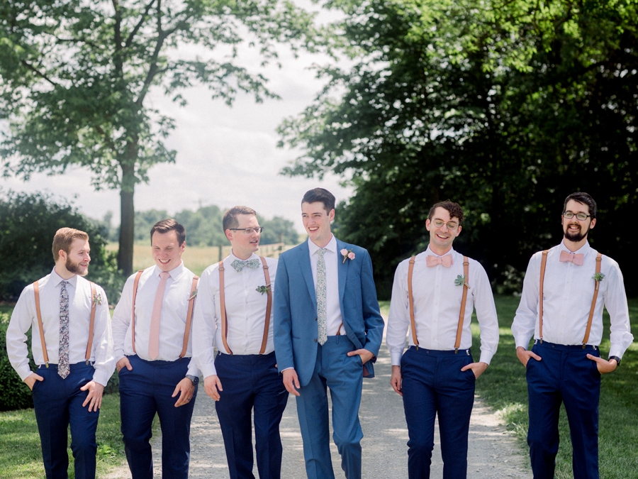 The groom walks with his at a Blue Bell Farm wedding by Love Tree Studios.