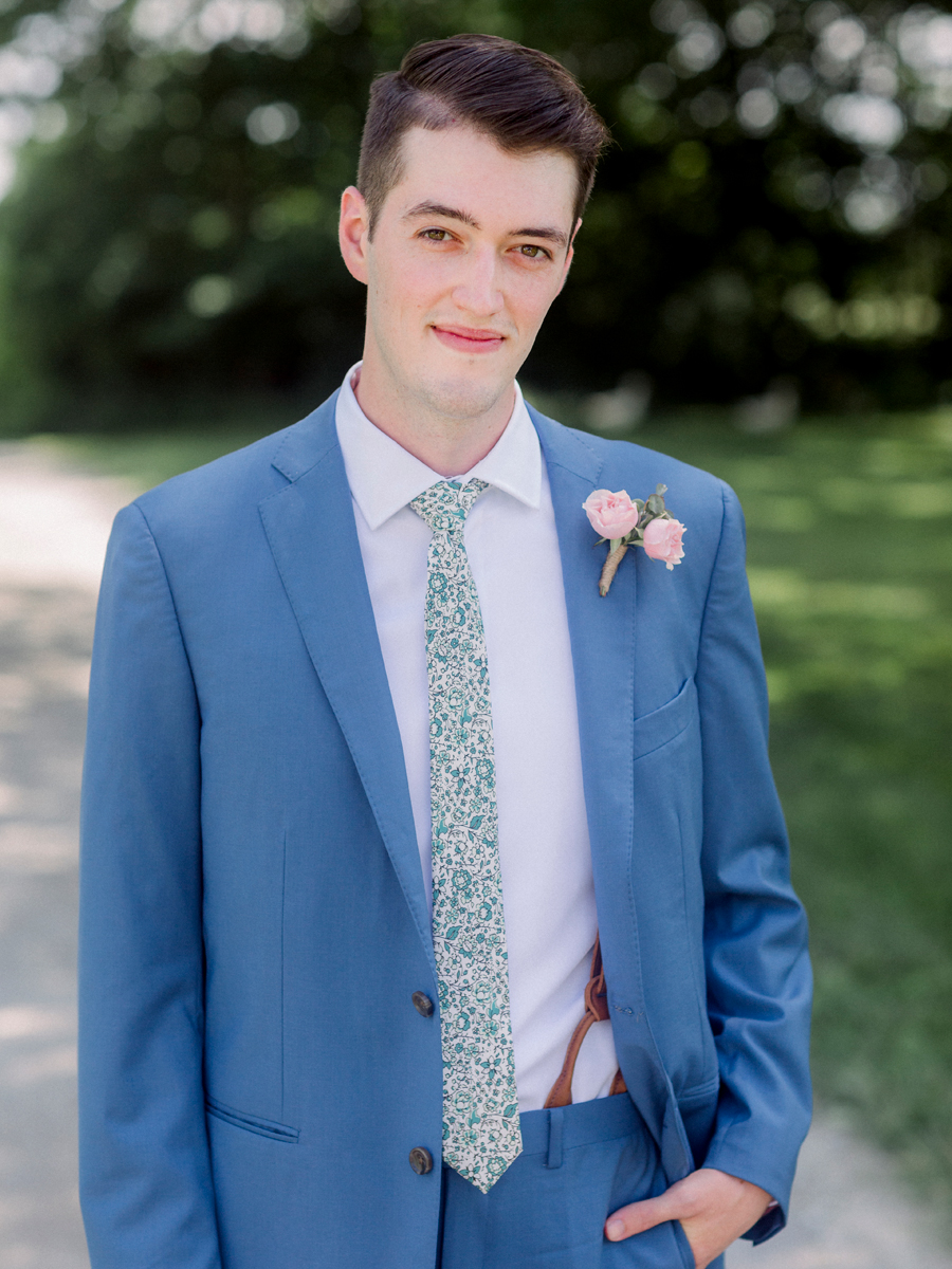 The groom takes a portrait at a Blue Bell Farm wedding by Love Tree Studios.