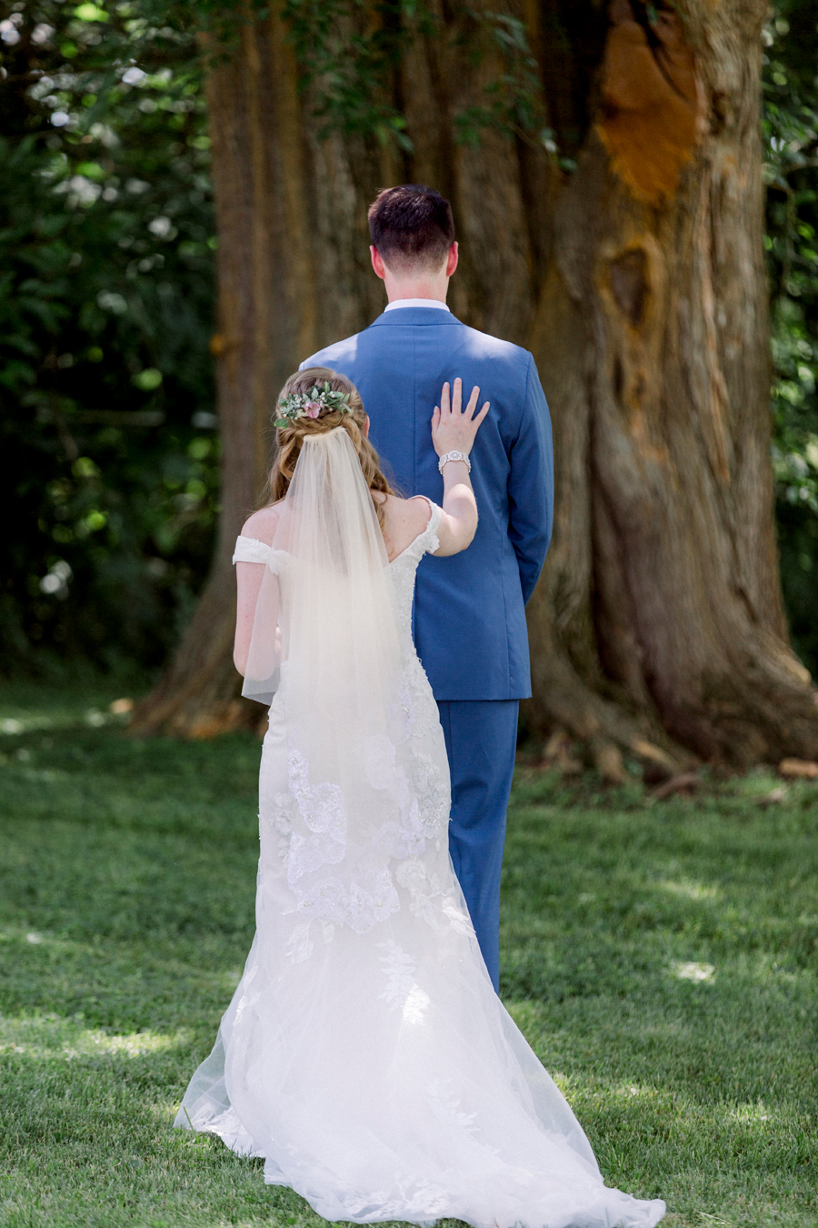 The bride taps the grooms shoulder during the first look at a Blue Bell Farm wedding by Love Tree Studios.