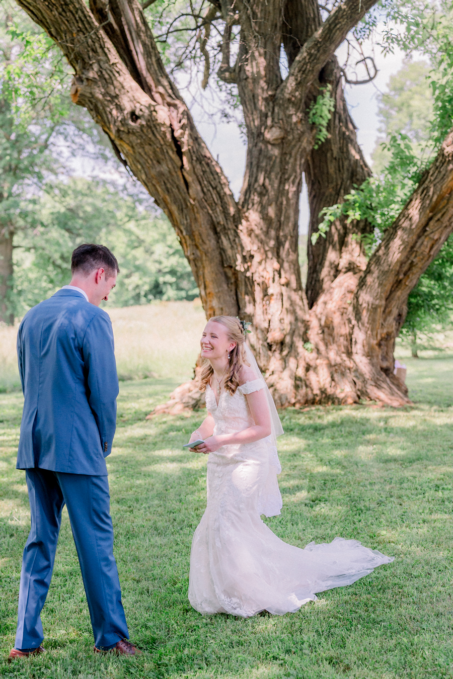 A bride and groom surprise each other during their first look at a Blue Bell Farm wedding by Love Tree Studios.