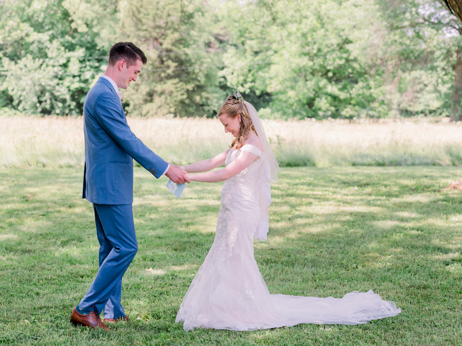 The bride and groom embrace during their first look at a Blue Bell Farm wedding by Love Tree Studios.