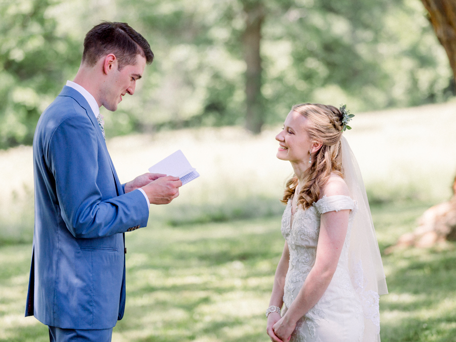 The groom reads his vows to the bride at a Blue Bell Farm wedding by Love Tree Studios.
