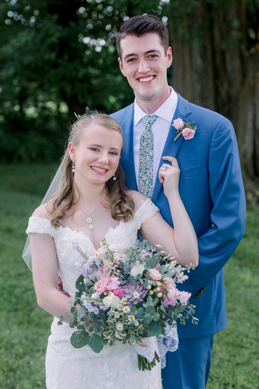 A bride and groom pose romantically at a Blue Bell Farm wedding by Love Tree Studios.