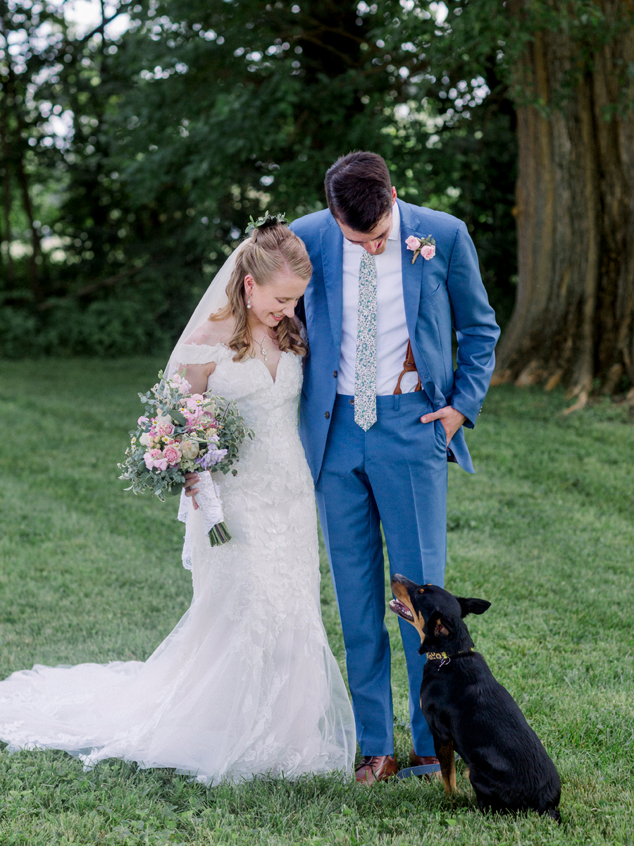 The bride and groom take photos with their dog at a Blue Bell Farm wedding by Love Tree Studios.
