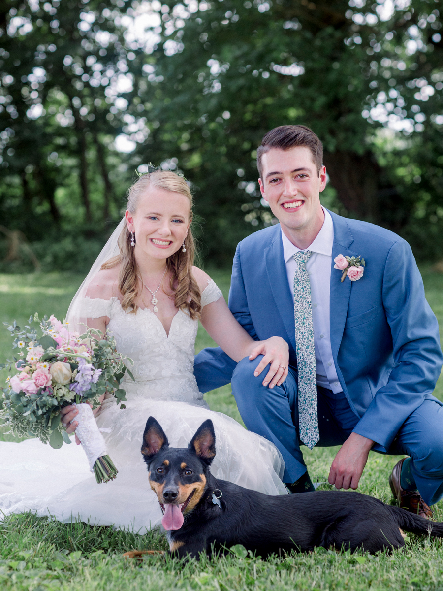 The bride and groom pose with their puppy at a Blue Bell Farm wedding by Love Tree Studios.