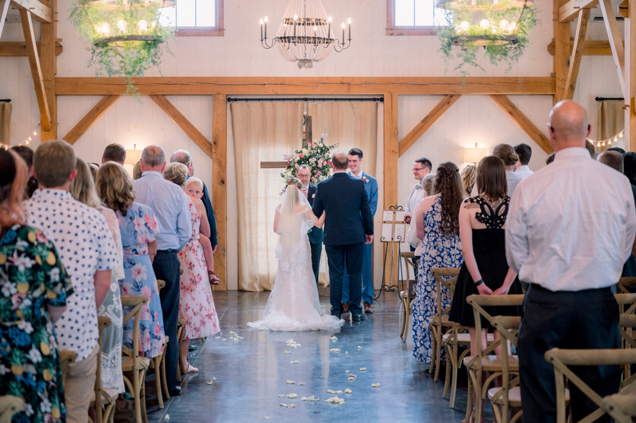 The bride and groom at the altar at a Blue Bell Farm wedding by Love Tree Studios.