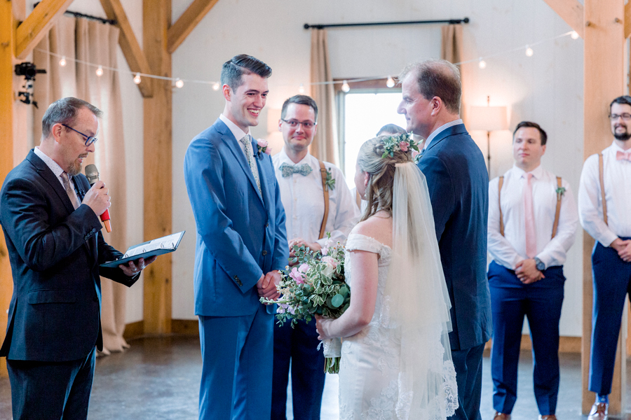 The groom greets the bride at the altar at a Blue Bell Farm wedding by Love Tree Studios.