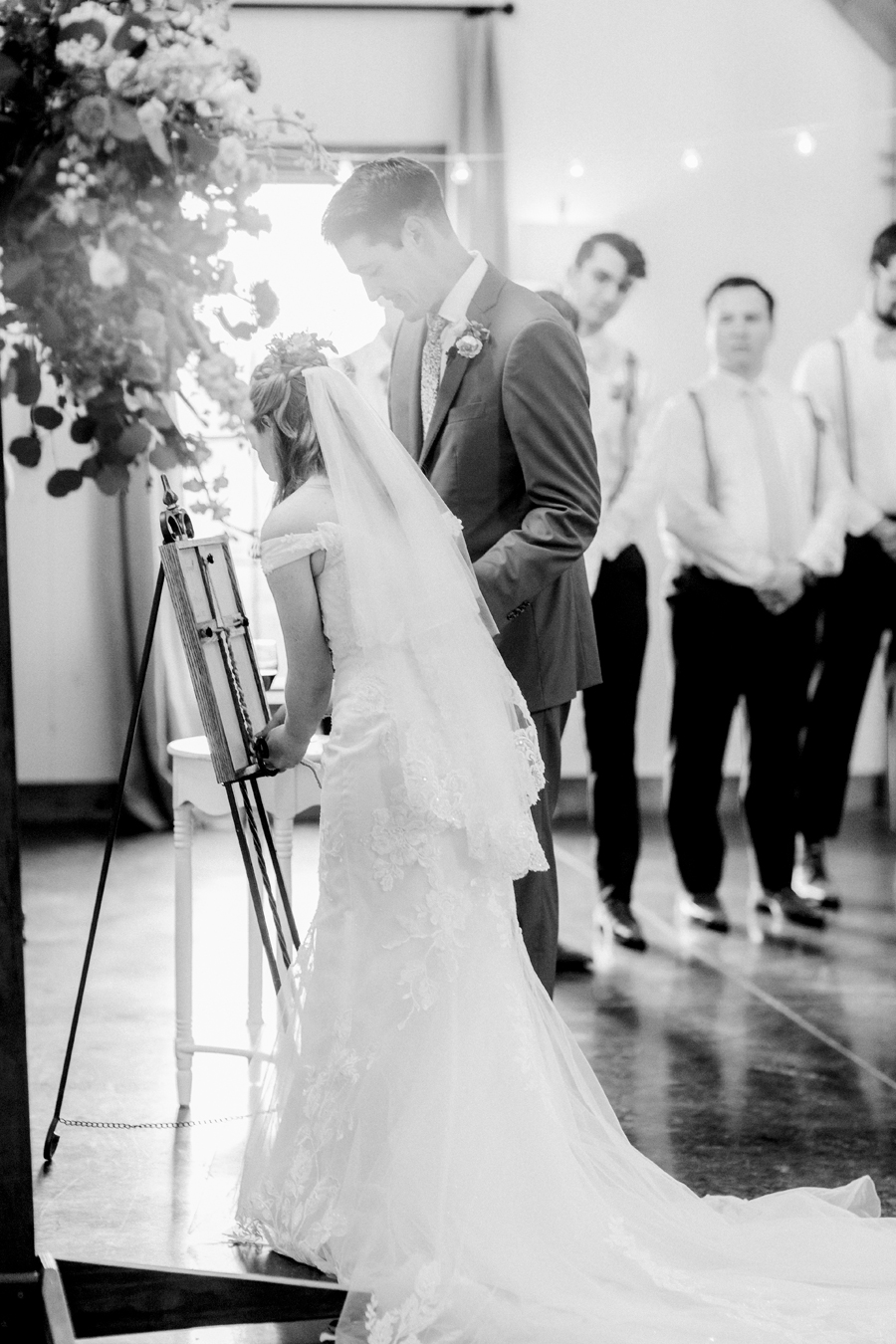 A black and white photos of the ceremony at a Blue Bell Farm wedding by Love Tree Studios.