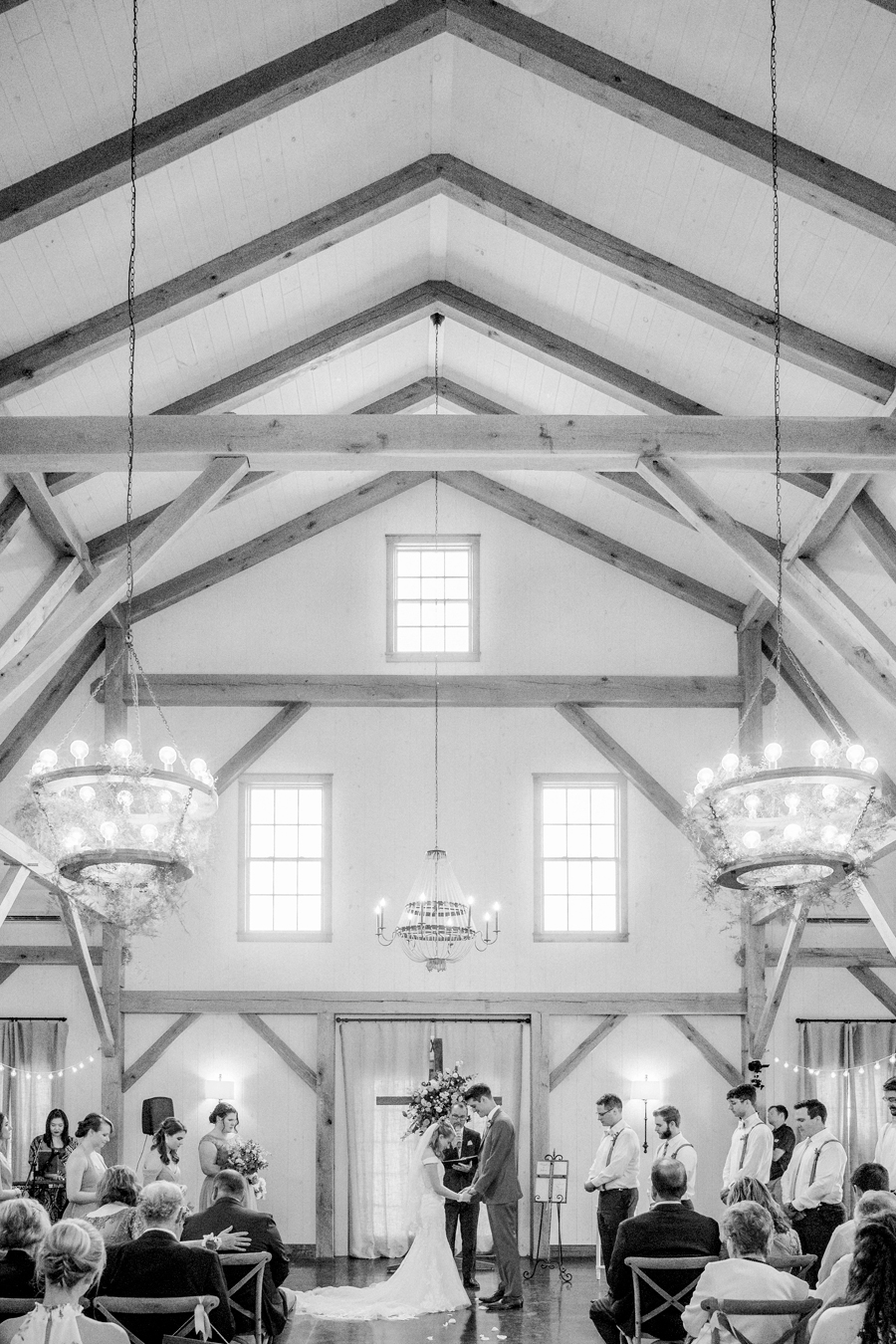The inside of the barn during a ceremony at a Blue Bell Farm wedding by Love Tree Studios.