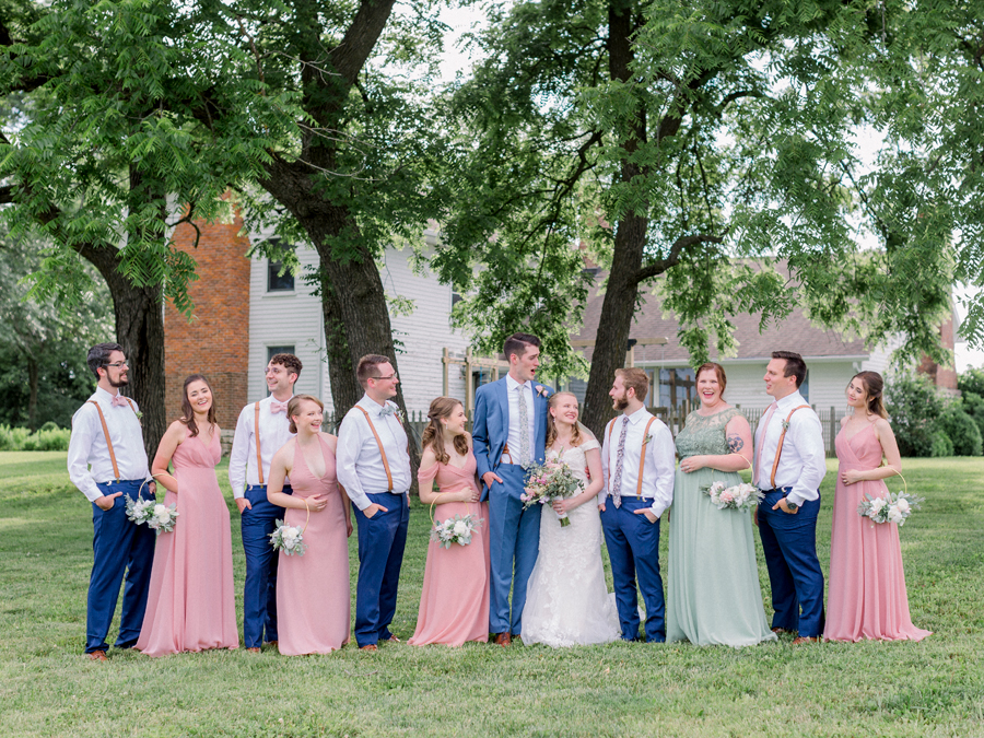 A wedding party laughs at a Blue Bell Farm wedding by Love Tree Studios.