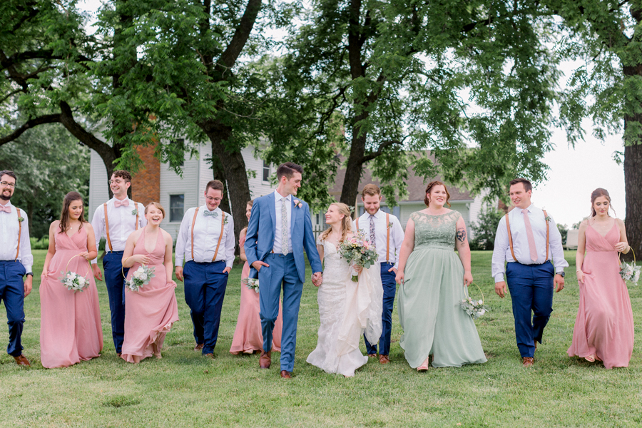 A wedding party walks toward the camera at a Blue Bell Farm wedding by Love Tree Studios.