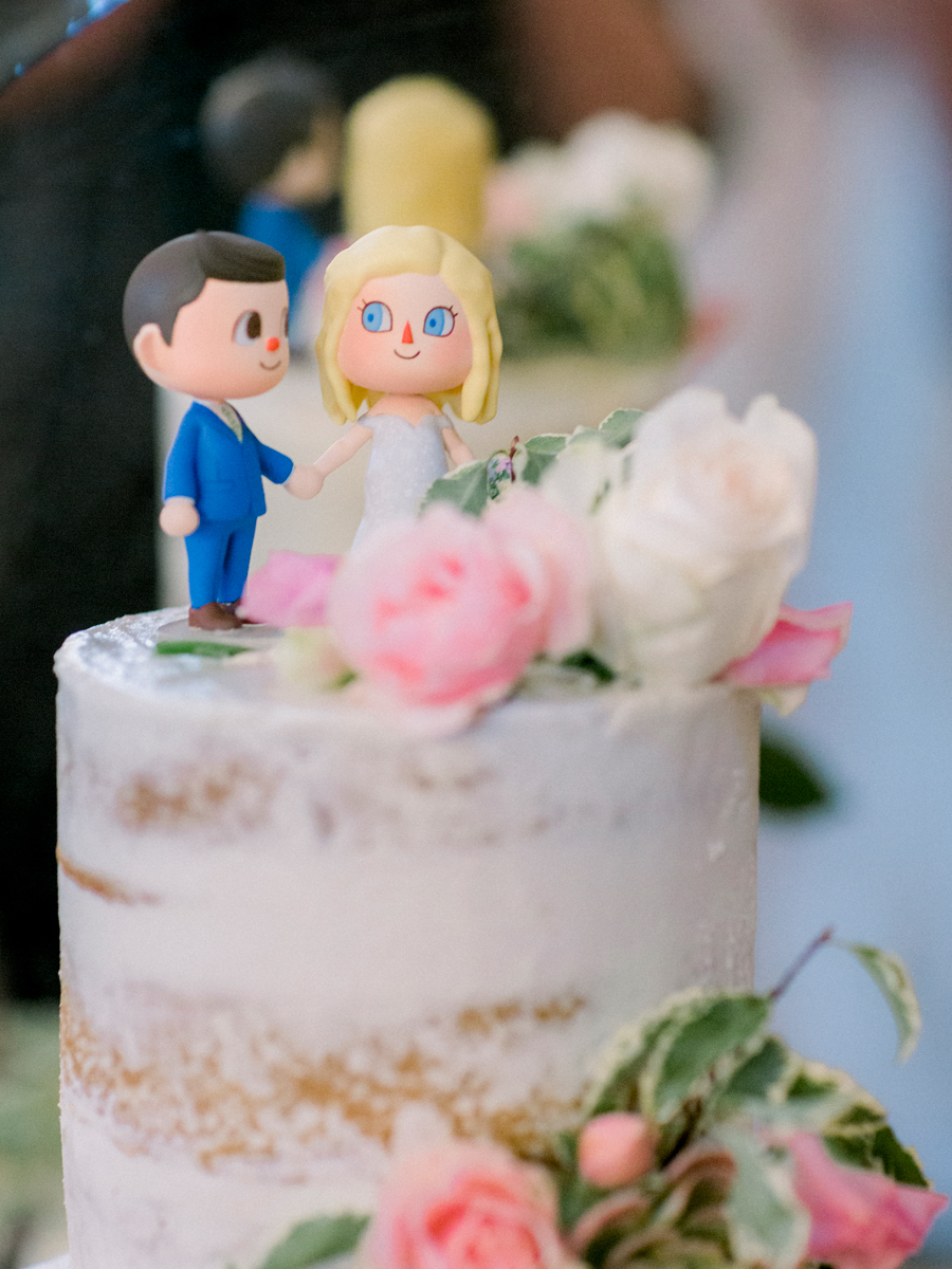 A photo of the wedding cake topper at a Blue Bell Farm wedding by Love Tree Studios.