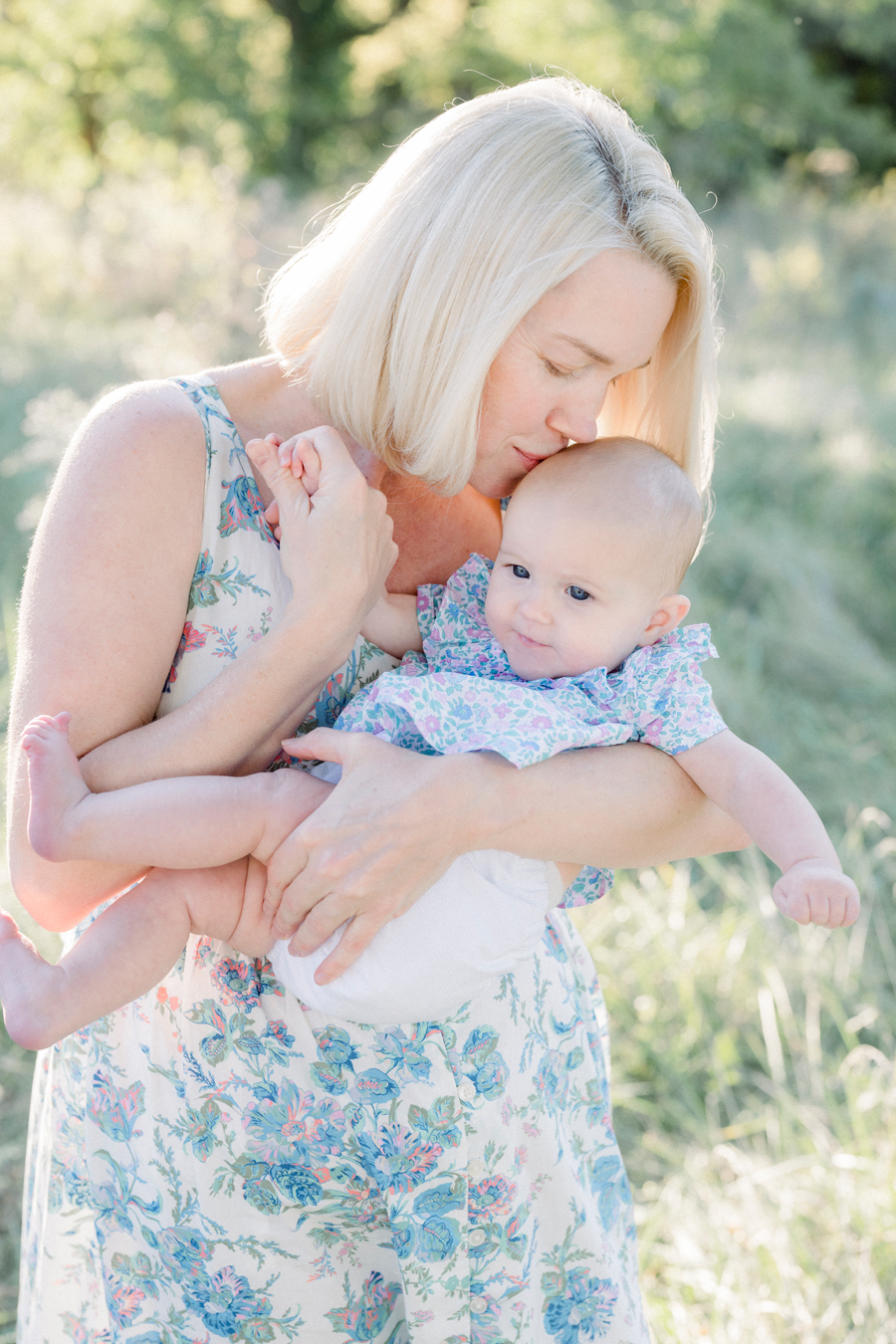 A mom snuggles with her baby during their Fayette Missouri family photography session by Love Tree Studios.