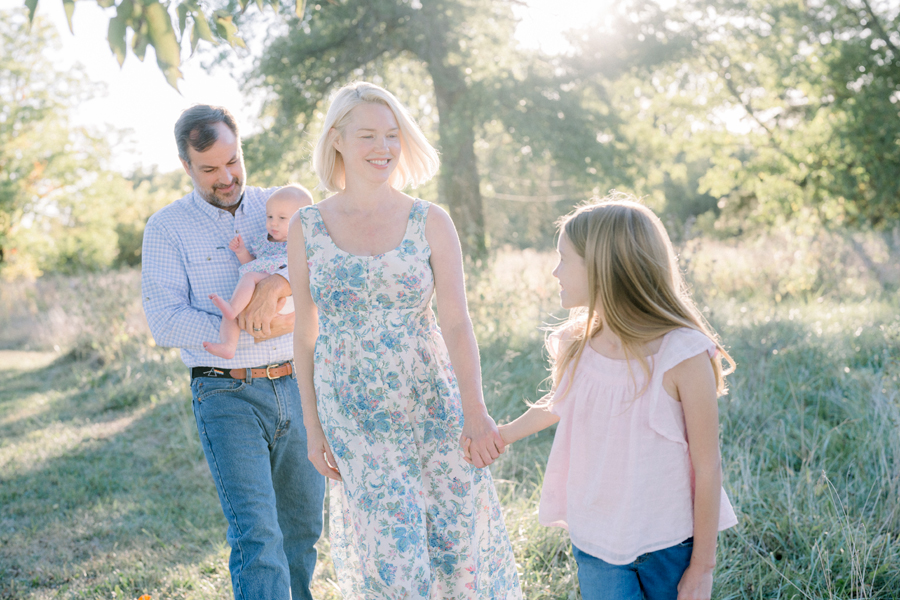 A family walks hand in hand during their Fayette Missouri family photography session.
