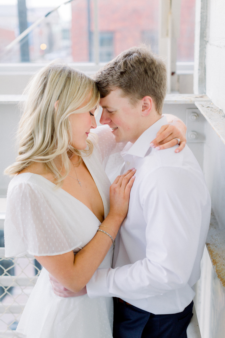 A couple takes photos for their engagement session in downtown Columbia, Missouri by Love Tree Studios.