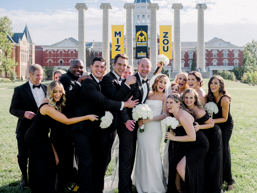A bride and groom take portraits with their wedding party on Mizzou's Quad for their Stephens College wedding photographed by Missouri wedding photographer Love Tree Studios.