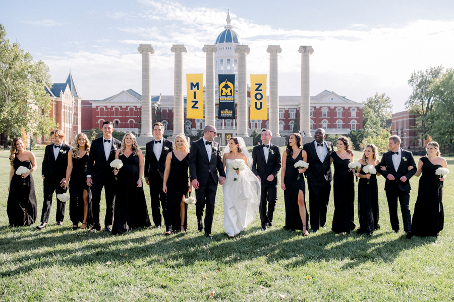 A bride and groom take portraits with their wedding party on Mizzou's Quad for their Stephens College wedding photographed by Missouri wedding photographer Love Tree Studios.