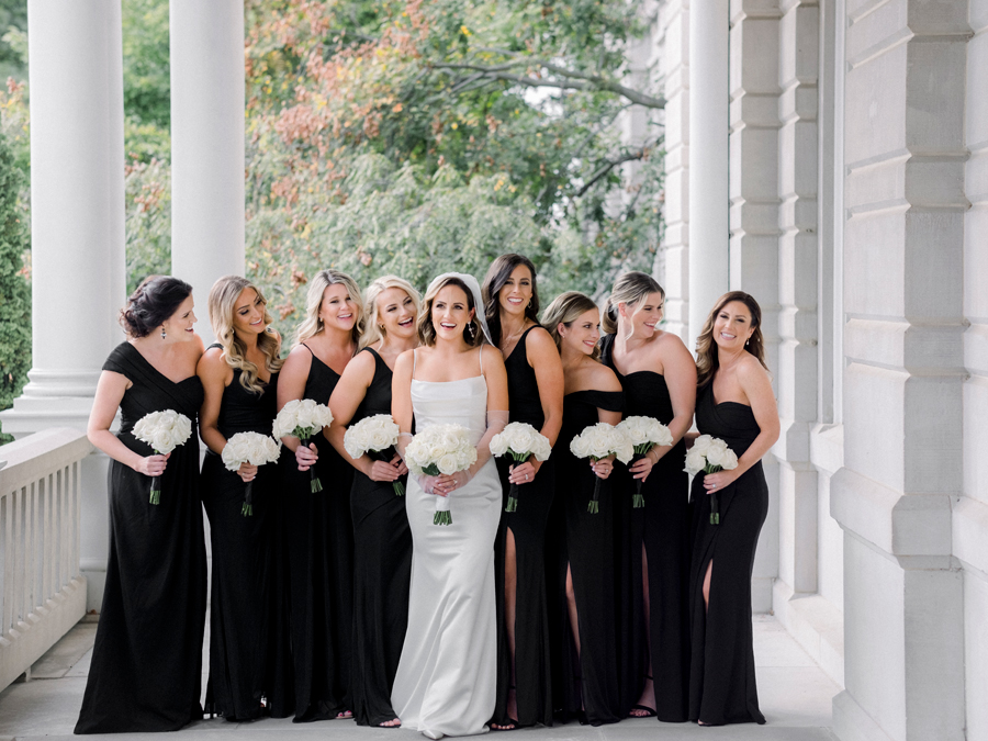 A bride poses with her bridesmaids on the University of Missouri's campus for her Stephens College wedding photographed by Columbia, Missouri wedding photographer Love Tree Studios.