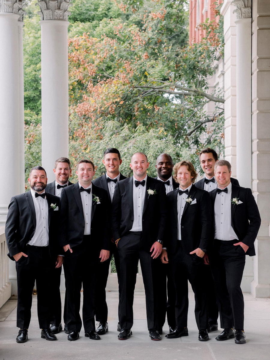 A groom poses with his groomsmen on the University of Missouri's campus for his Stephens College wedding photographed by Columbia, Missouri wedding photographer Love Tree Studios.