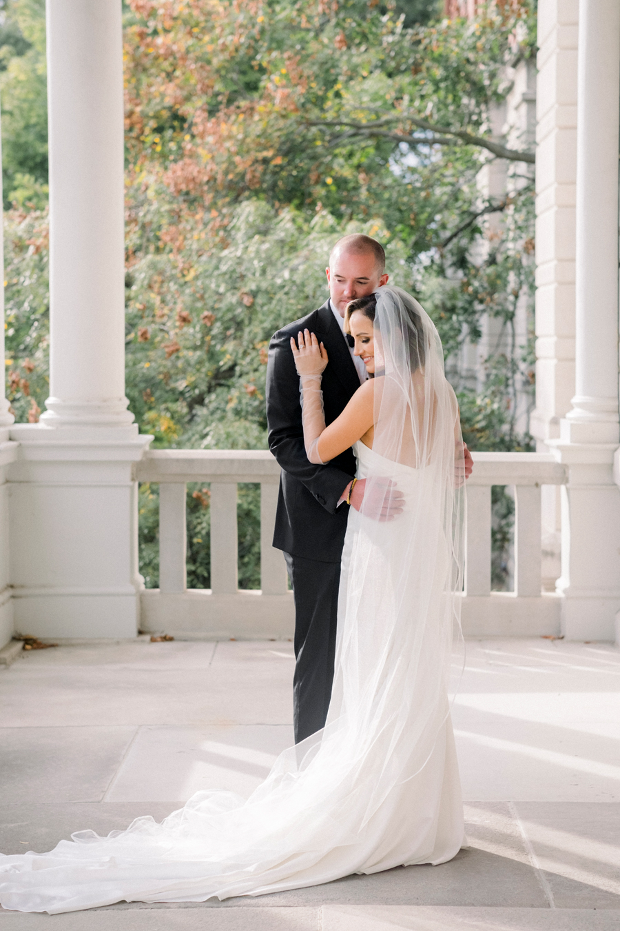 A bride and groom take portraits on the University of Missouri's campus for their Stephens College wedding photographed by Columbia, Missouri wedding photographer Love Tree Studios.