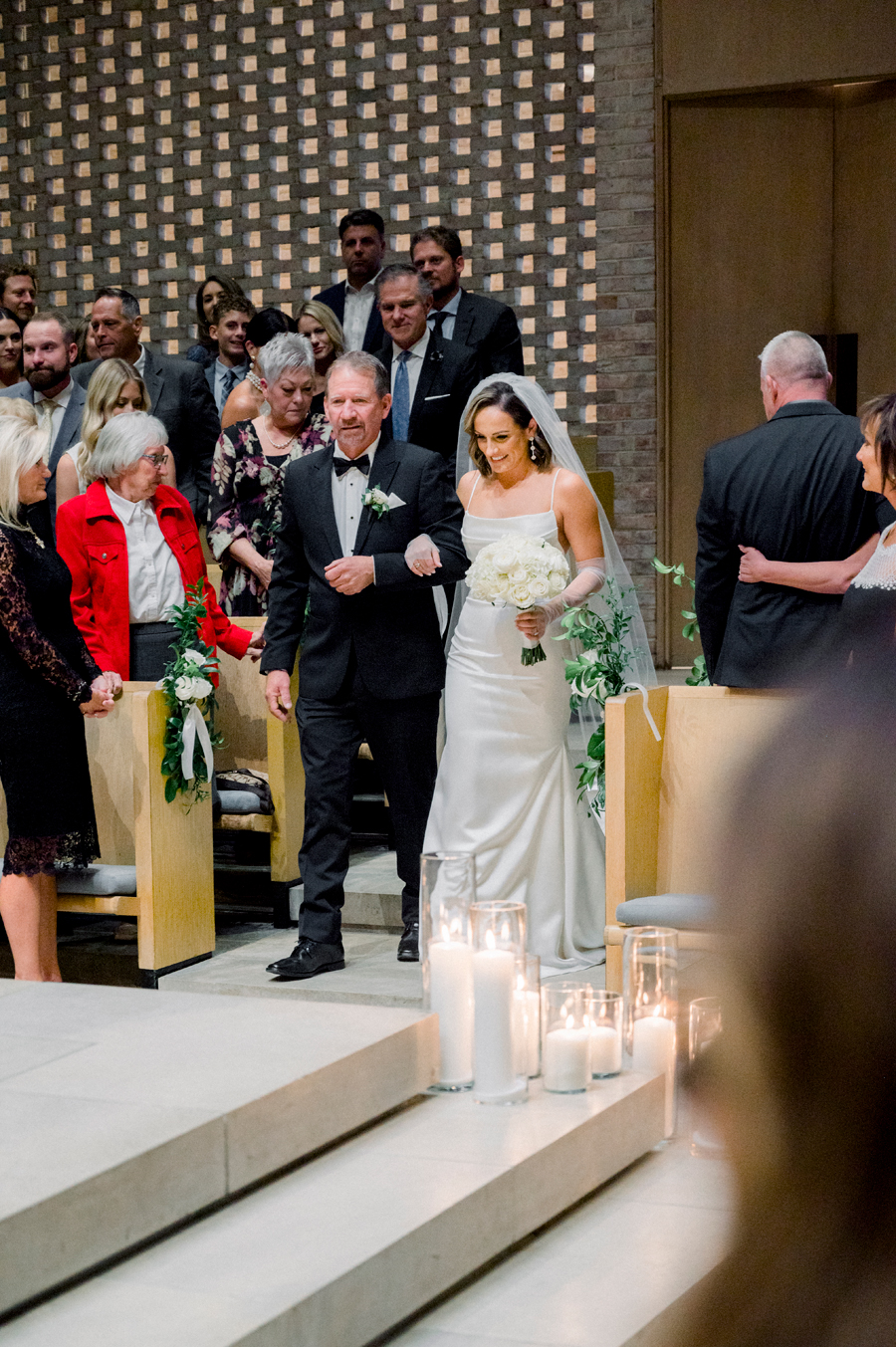 A walks down the aisle in Firestone Baars Chapel for her Stephens College wedding photographed by Columbia, Missouri wedding photographer Love Tree Studios.