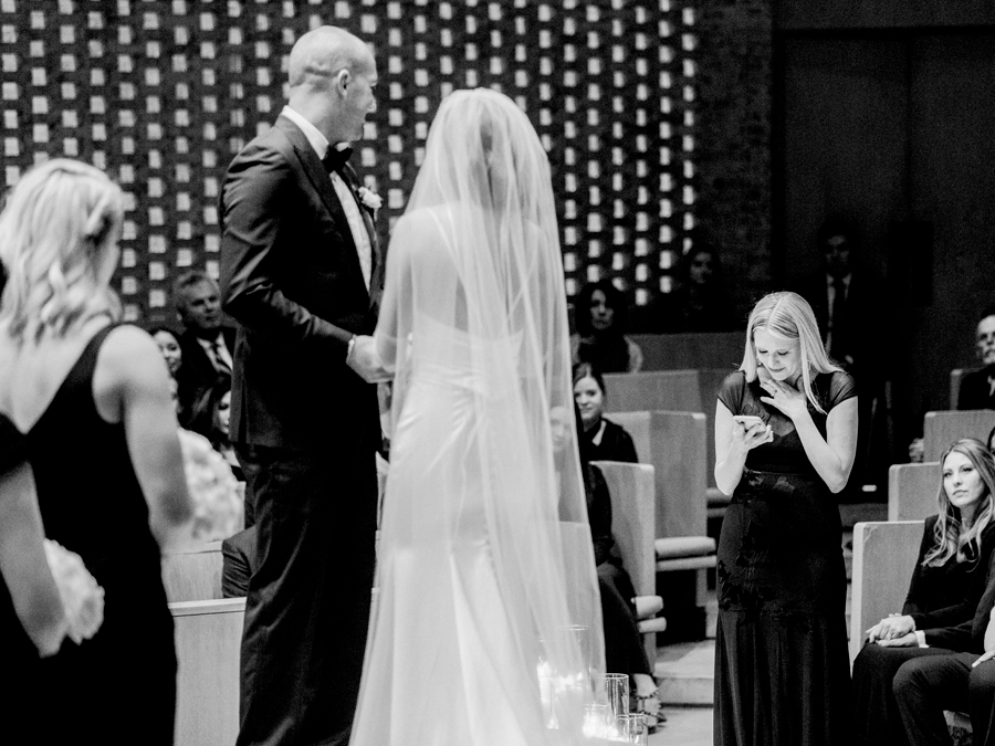 A bride and groom say their vows in Firestone Baars Chapel for their Stephens College wedding photographed by Columbia, Missouri wedding photographer Love Tree Studios.