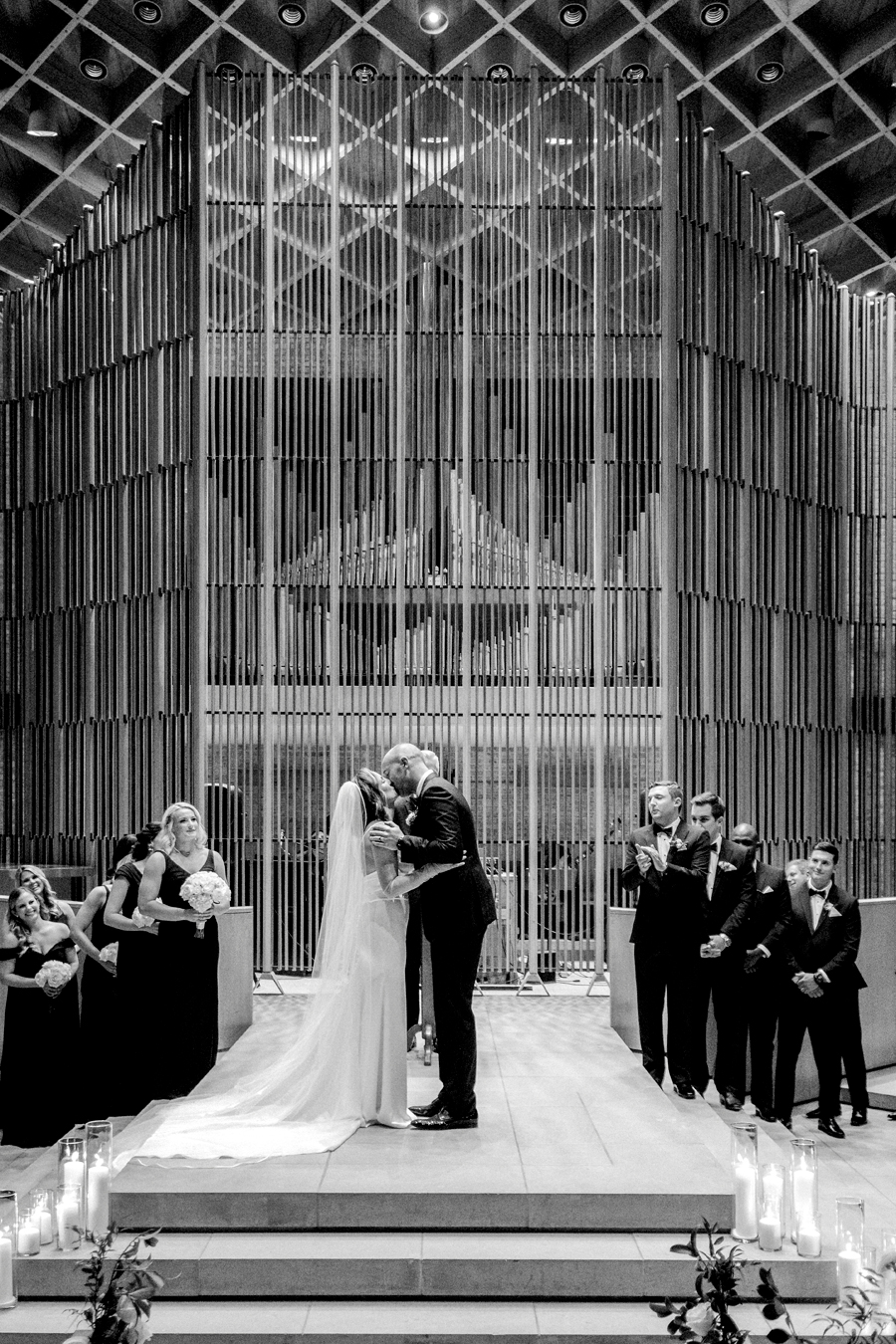 A bride and groom say their vows in Firestone Baars Chapel for their Stephens College wedding photographed by Columbia, Missouri wedding photographer Love Tree Studios.