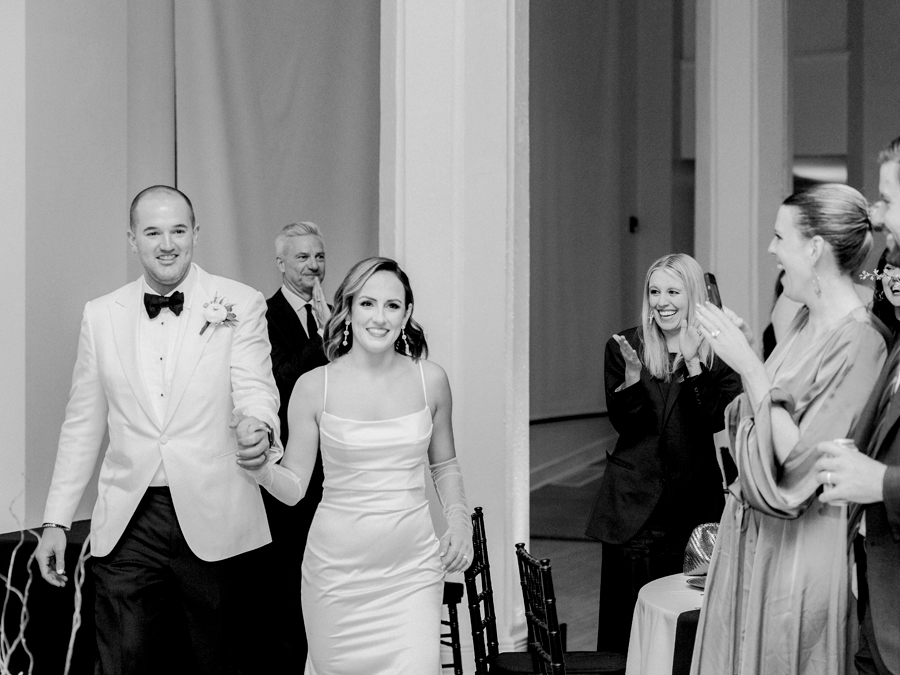 The bride and groom enter their wedding reception in Kimball Ballroom for their Stephens College wedding photographed by Columbia, Missouri wedding photographer Love Tree Studios.