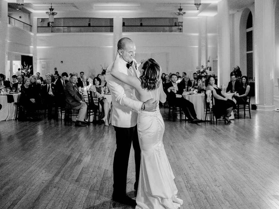 A bride and groom dance the first dance during their wedding reception in Kimball Ballroom at their Stephens College wedding photographed by Columbia, Missouri wedding photographer Love Tree Studios.