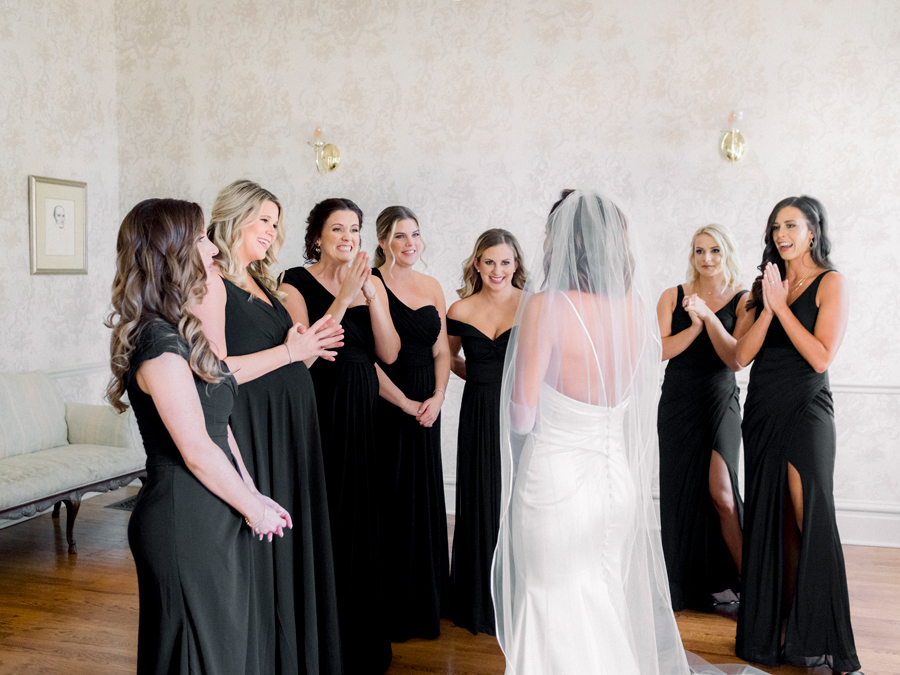 A bride does a first look with her bridesmaids before her Stephens College wedding photographed by Jefferson City, Missouri wedding photographer Love Tree Studios.