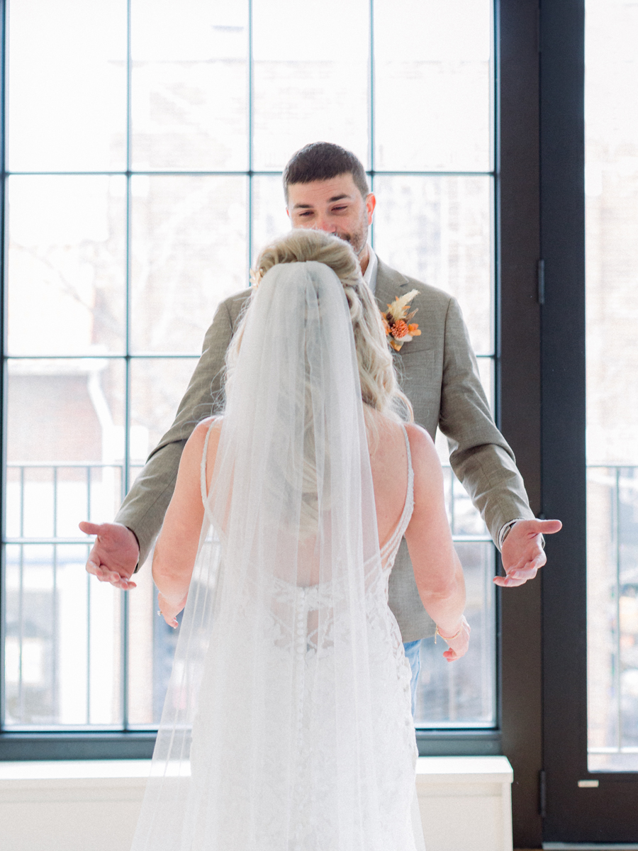 The bride and groom do a first look before their Atrium on Tenth wedding in Columbia, Missouri by Love Tree Studios.