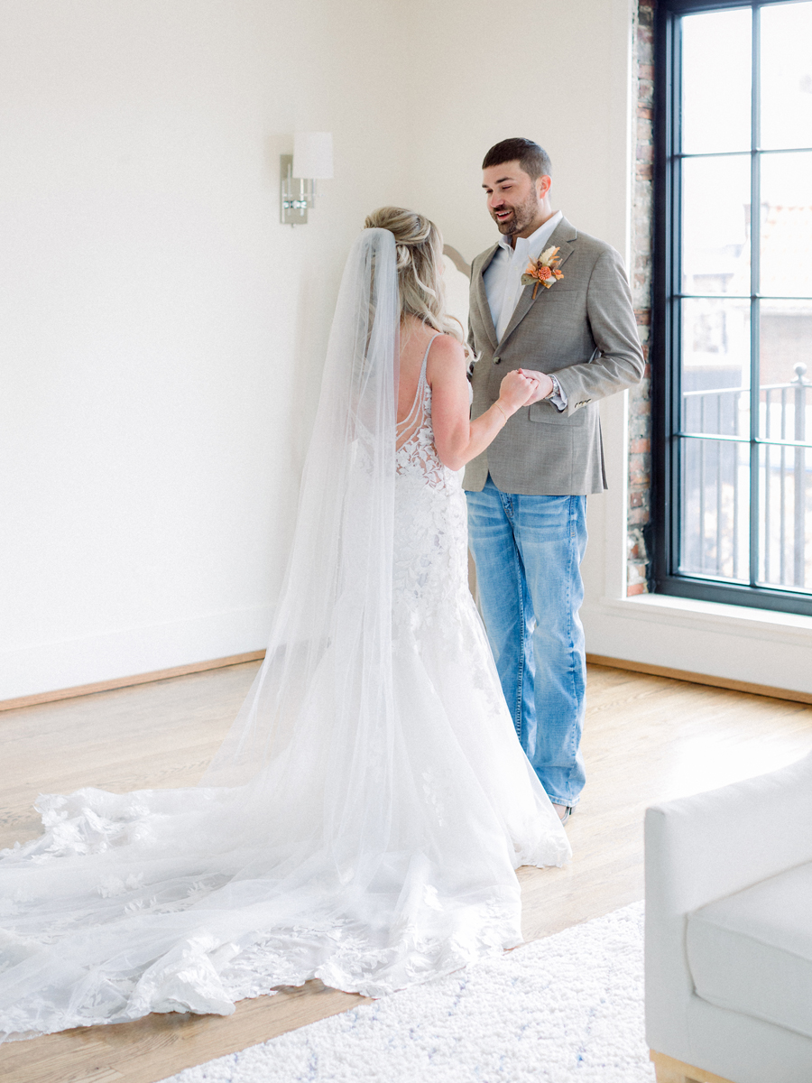 The bride and groom do a first look before their Atrium on Tenth wedding in Columbia, Missouri by Love Tree Studios.