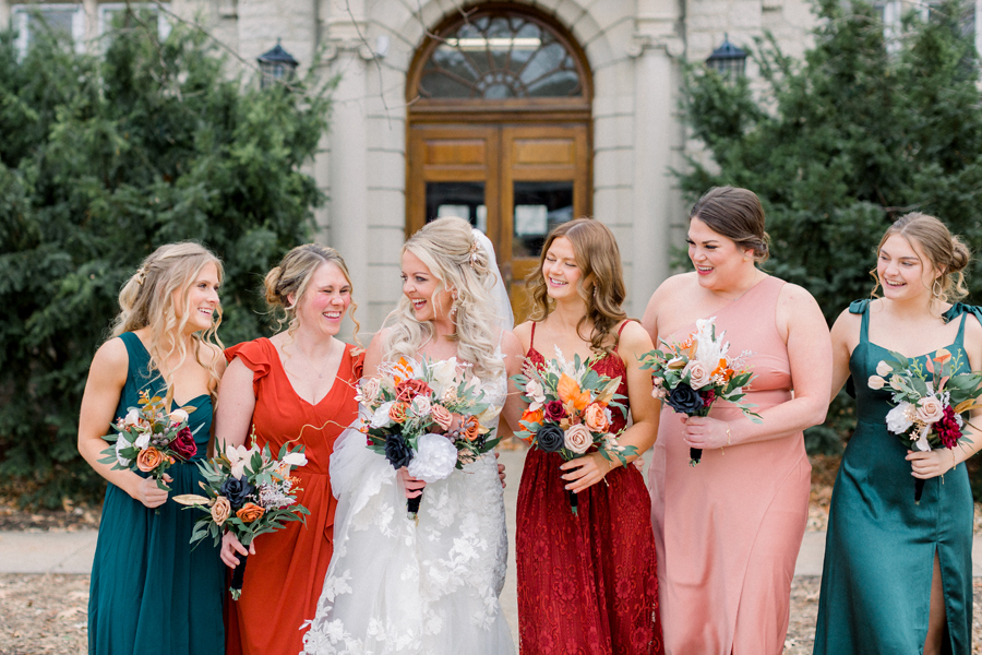 The bride and bridesmaids laugh during portraits on Mizzou campus before their Atrium on Tenth wedding in Columbia, Missouri by Love Tree Studios.