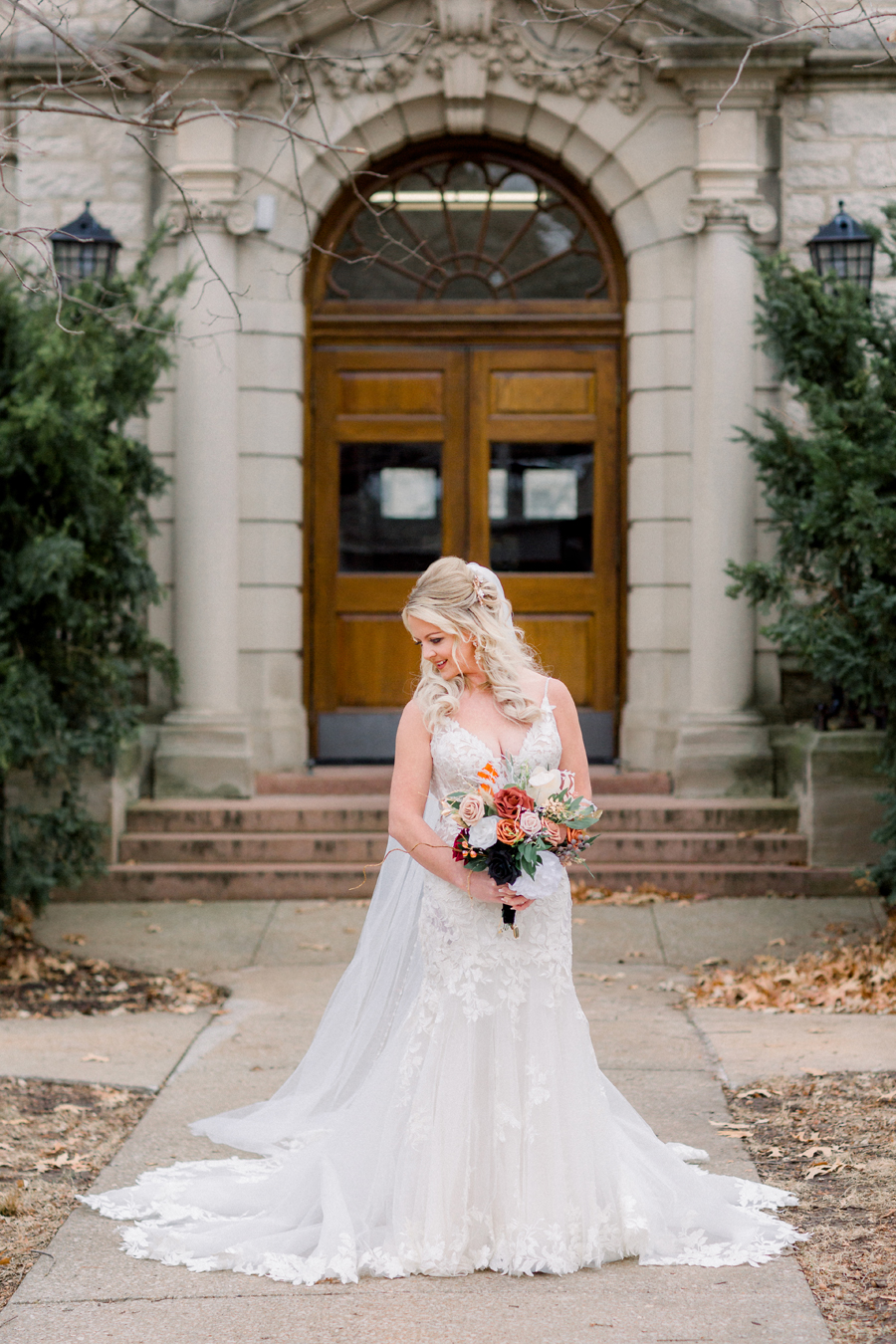 The bride poses for portraits on Mizzou campus before her Atrium on Tenth wedding in Columbia, Missouri by Love Tree Studios.