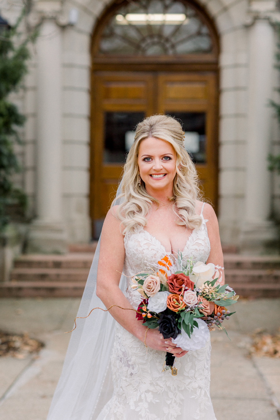 The bride poses for portraits on Mizzou campus before her Atrium on Tenth wedding in Columbia, Missouri by Love Tree Studios.