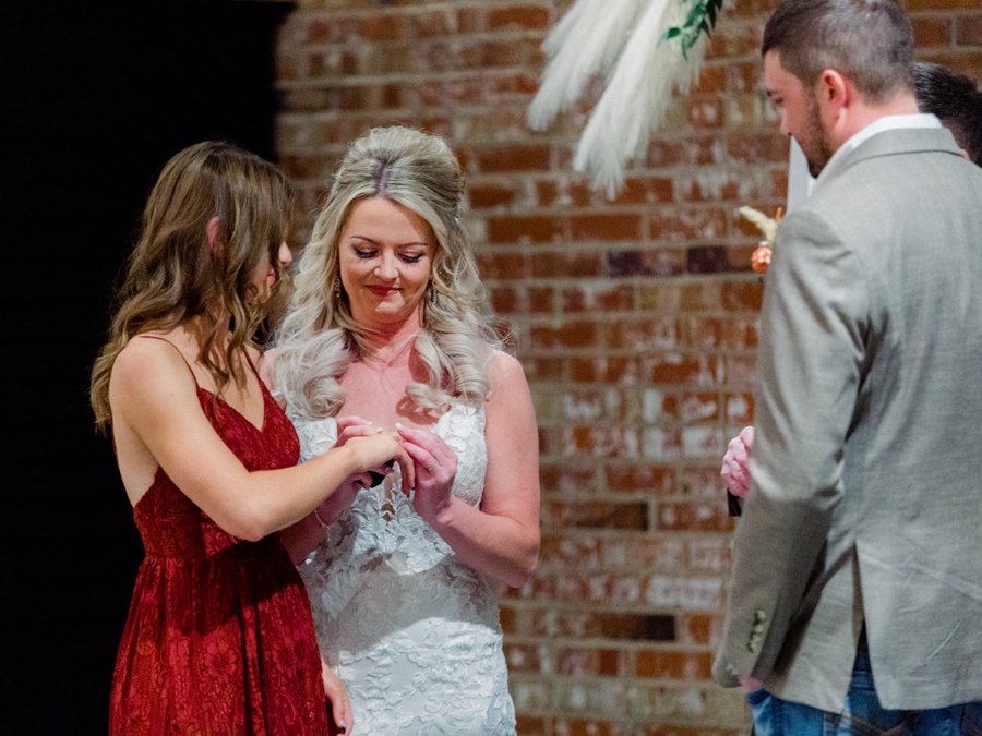 A bride and groom exchange vows for their wedding at Atrium on Tenth wedding in Columbia, Missouri by Love Tree Studios.