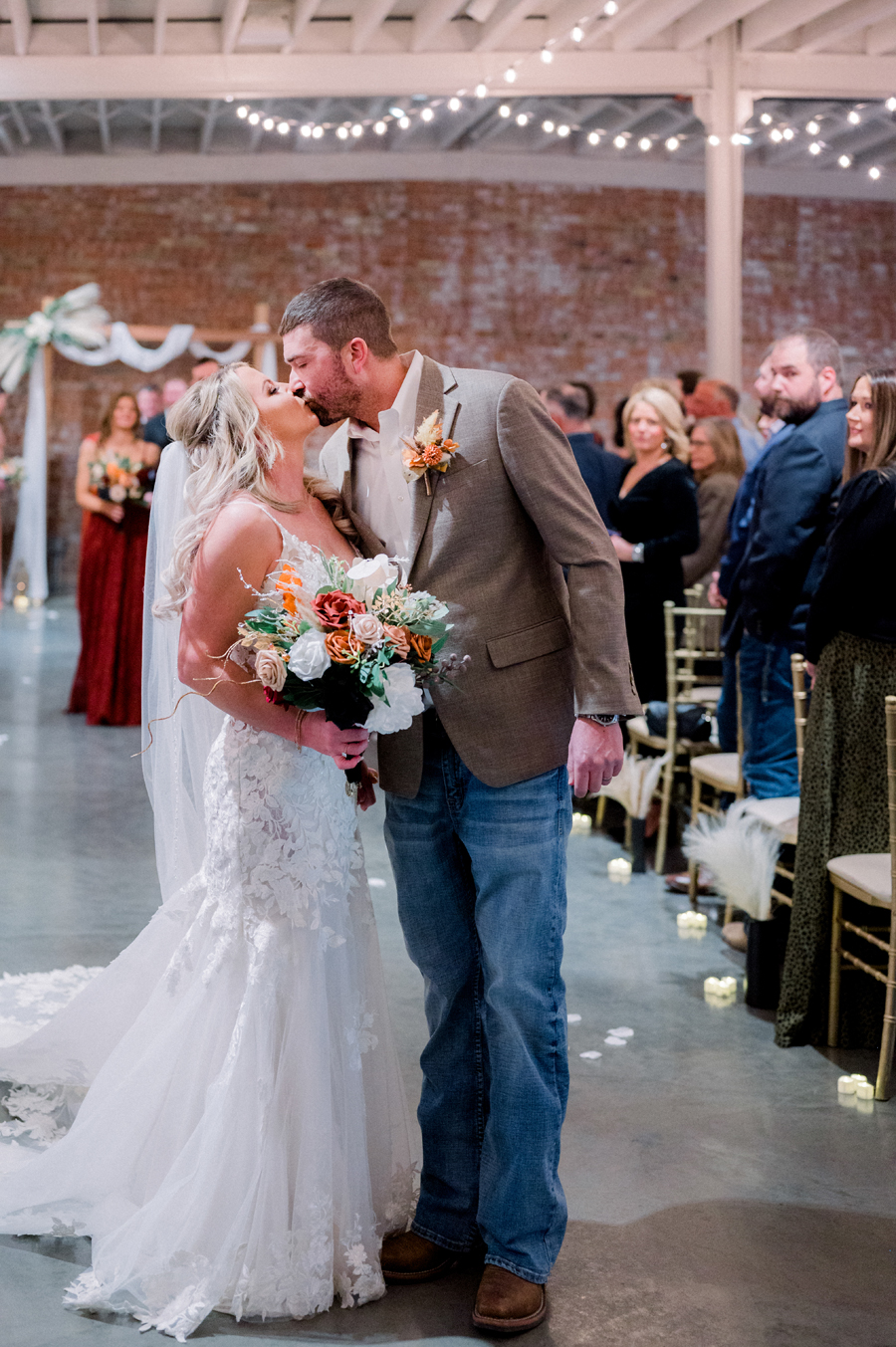 A bride and groom exchange vows for their wedding at Atrium on Tenth wedding in Columbia, Missouri by Love Tree Studios.
