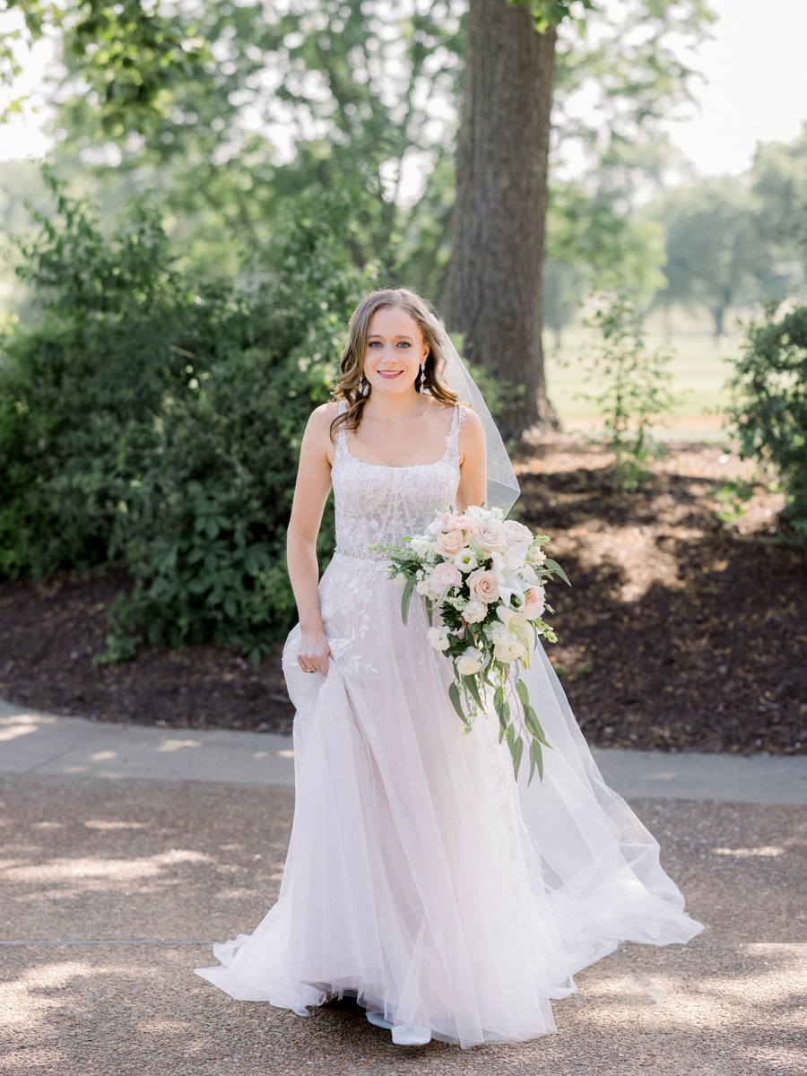 The bride poses in her beautiful gown at her Columbia Country Club wedding by Missouri photographer Love Tree Studios.