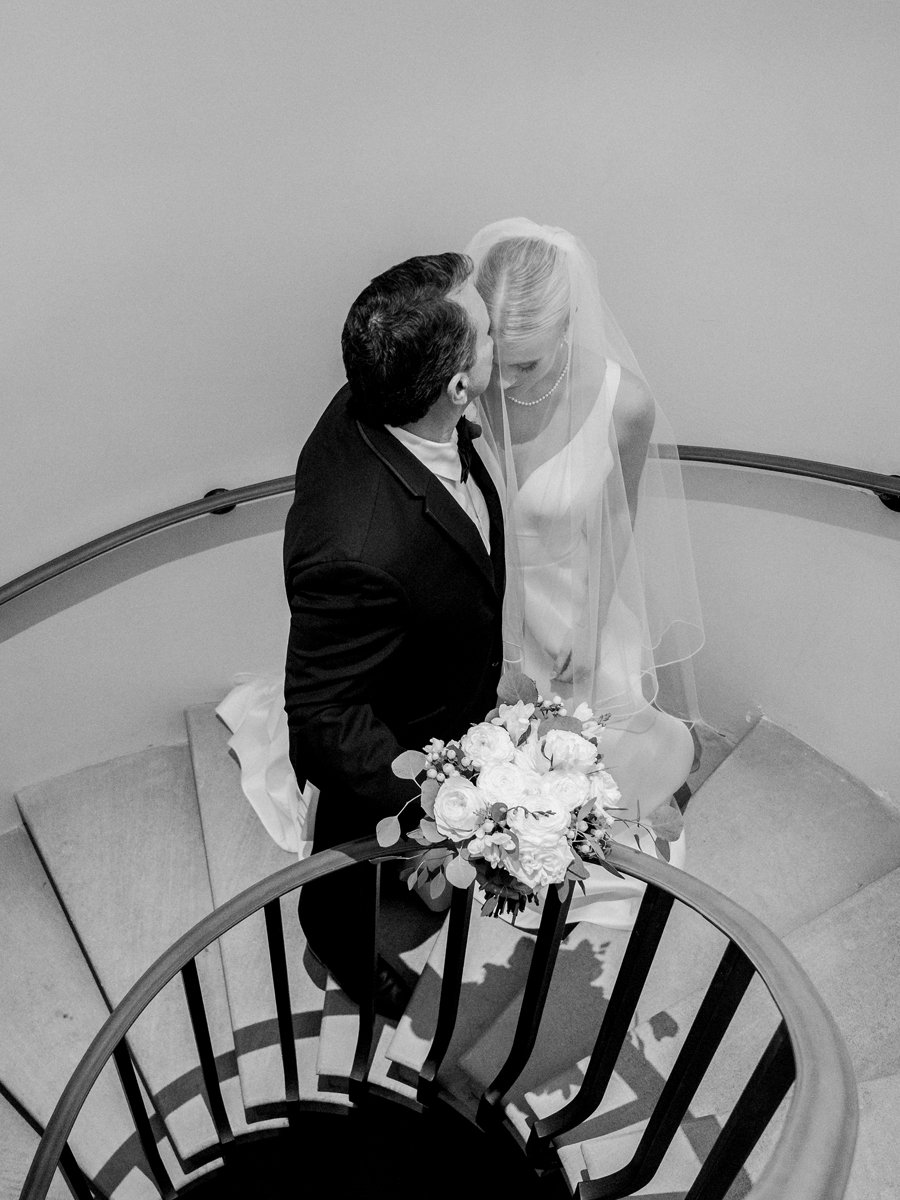 The bride and her father share a moment in the circular stairwell at a Westminster College wedding by Love Tree Studios.