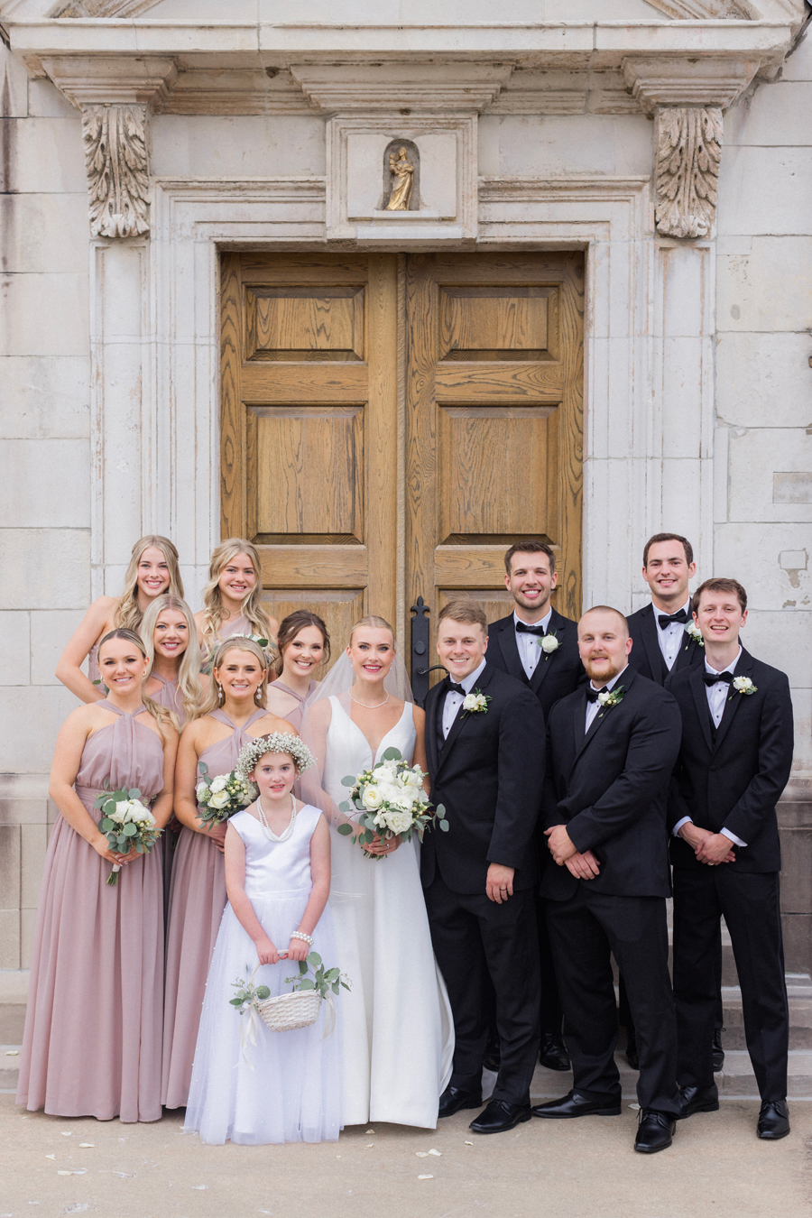 A wedding party poses for portraits at the Church of St. Mary, Aldermanbury at a Westminster College wedding by Love Tree Studios.