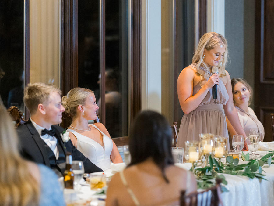 Toasts are given at a reception at the Club at Old Hawthorne for a Westminster College wedding by Love Tree Studios.
