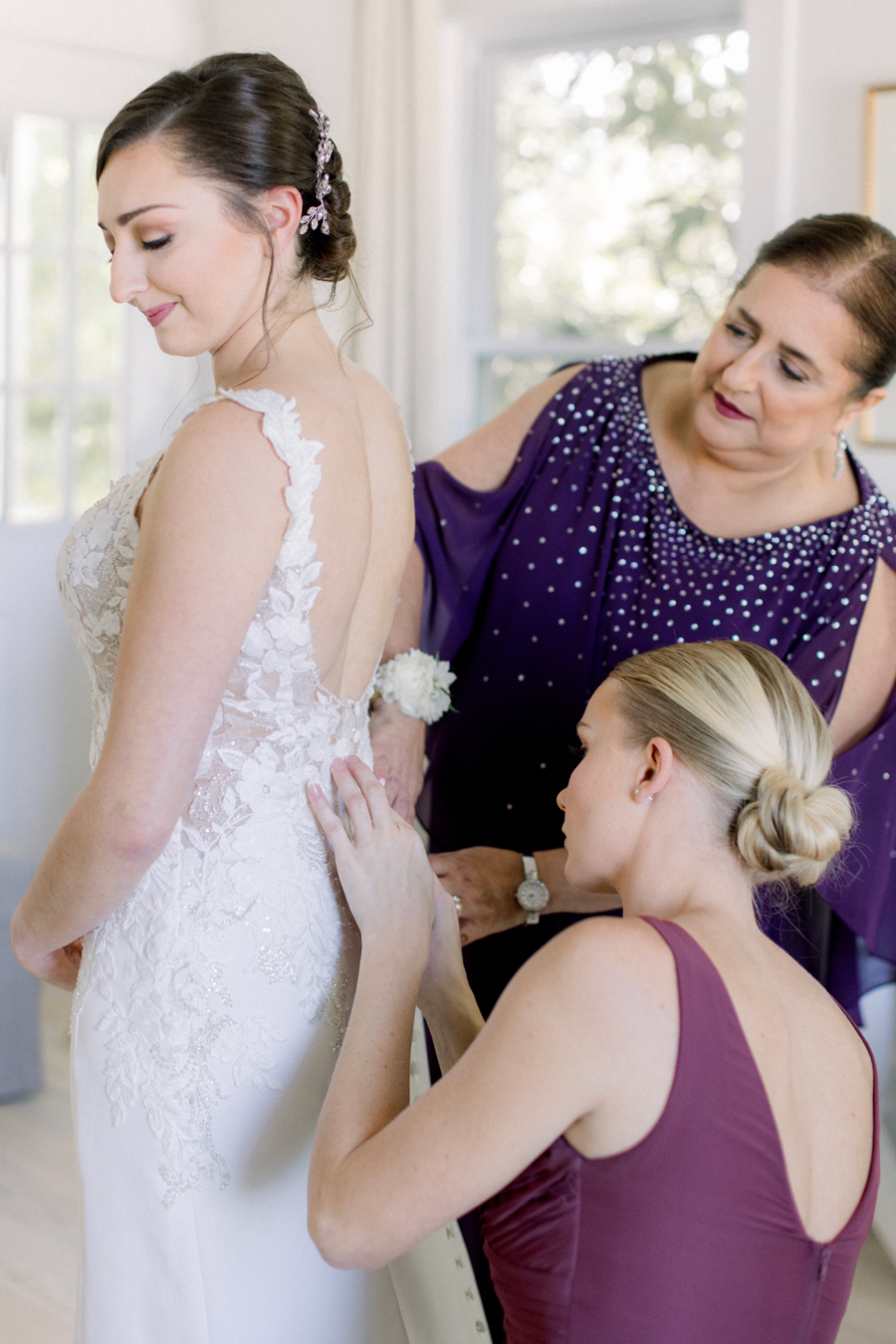 A bride puts her dress on for her Blue Bell Farm wedding by Missouri wedding photographer Love Tree Studios.