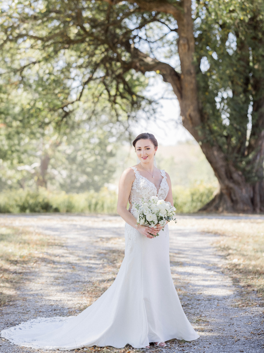 A bride poses for portraits at her Blue Bell Farm wedding by Missouri wedding photographer Love Tree Studios.
