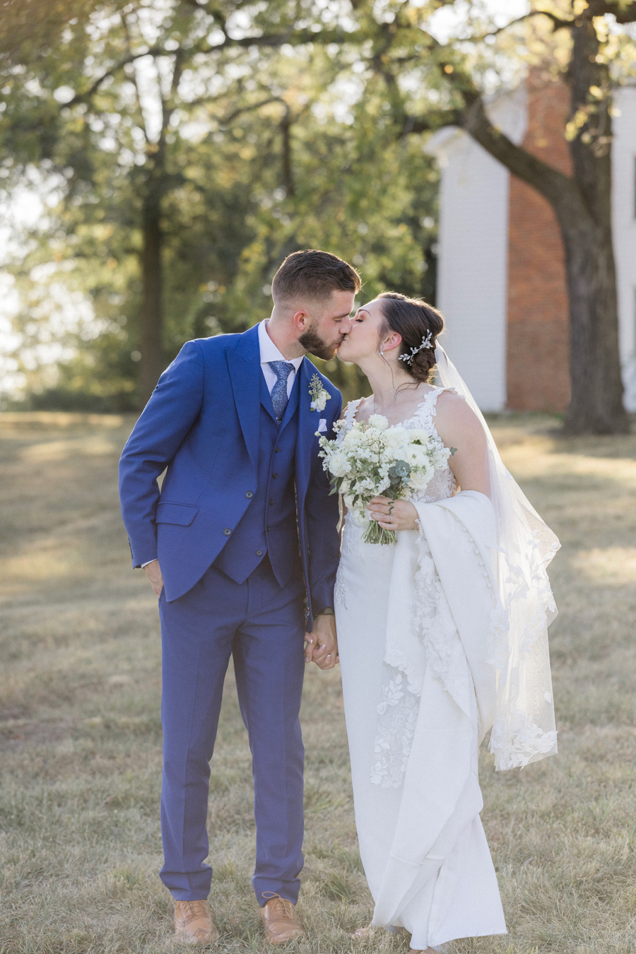 The bride and groom take portraits at their Blue Bell Farm wedding by Missouri wedding photographer Love Tree Studios.