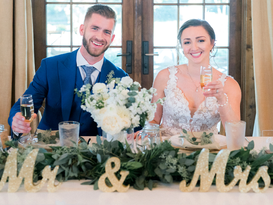 The bride and groom enter their wedding reception and listen to toasts at their Blue Bell Farm wedding by Missouri wedding photographer Love Tree Studios.