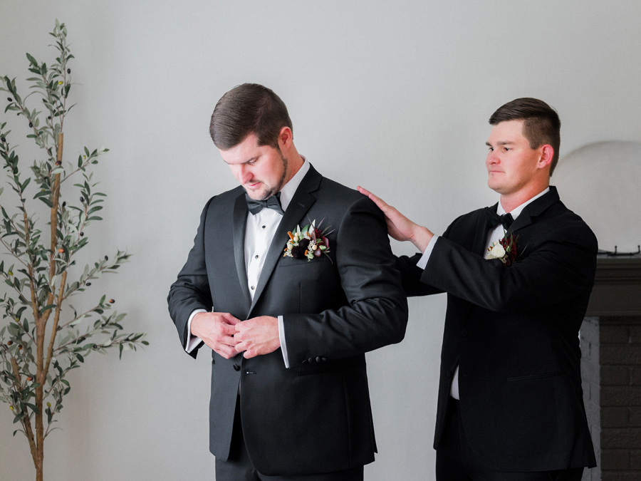 A groom prepares for his Jefferson City, Missouri wedding while being photographed by Love Tree Studios.