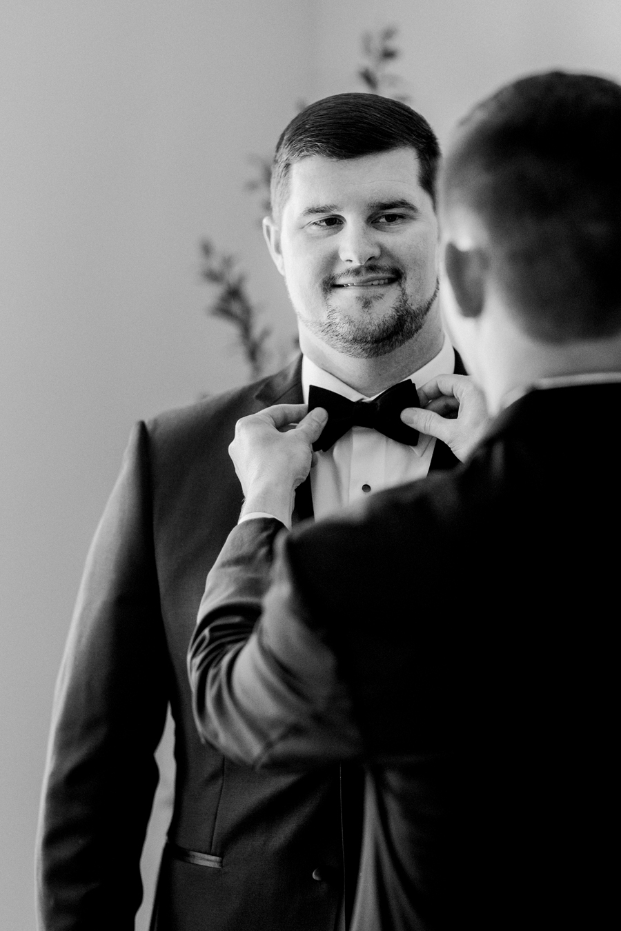 A groom prepares for his Jefferson City, Missouri wedding while being photographed by Love Tree Studios.