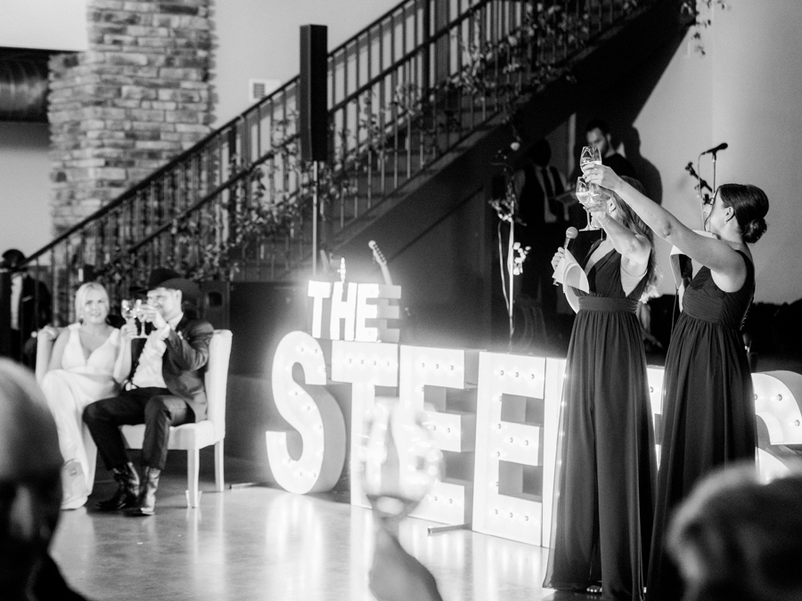Toast are given at Capital Bluffs during a Jefferson City wedding photographed by Love Tree Studios.