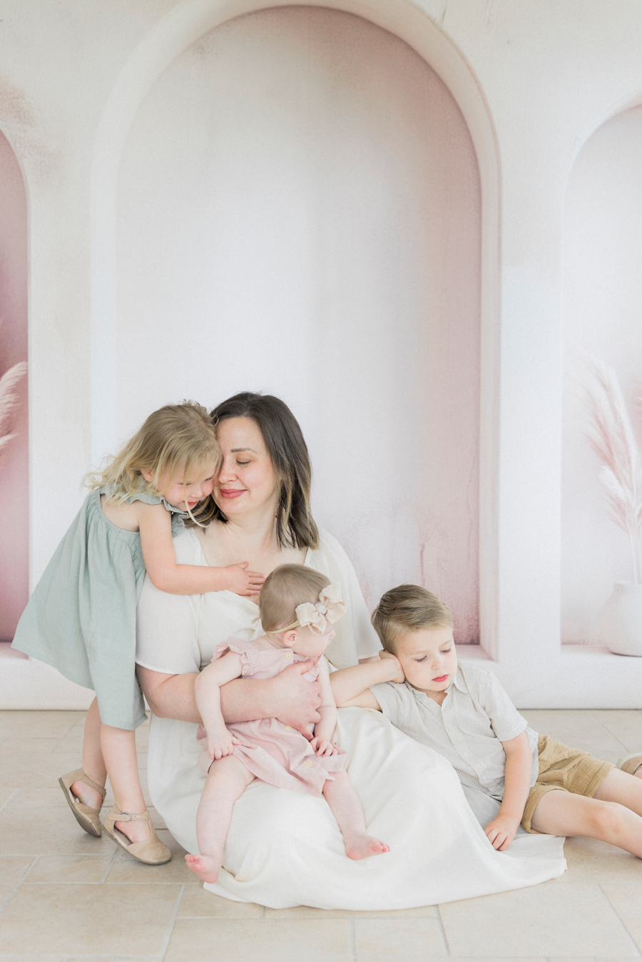 A beautiful mother poses with her three children for a motherhood mini session by Columbia, Missouri family photographer Love Tree Studios.