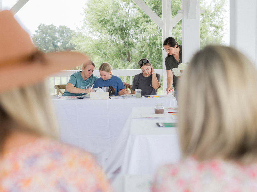 St. Louis artist Caitlin Allen instructing attendees on watercolor techniques at the Blue Bell Farm paint and picnic event.